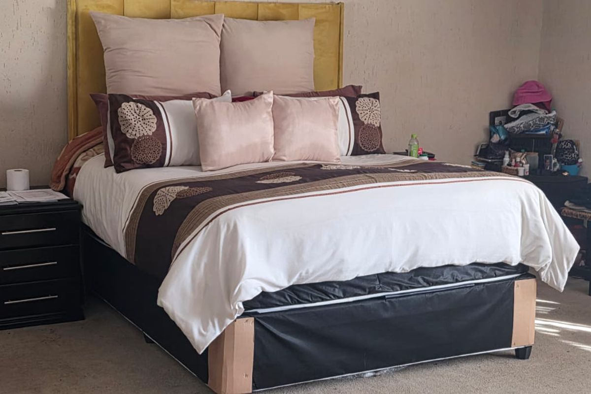 A bedroom featuring textured wall finishes and carpeted flooring.