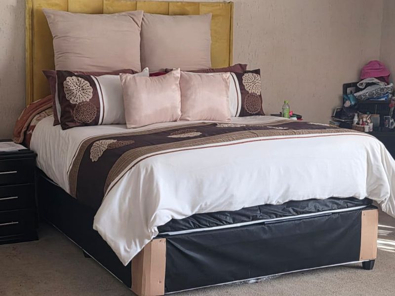 A bedroom featuring textured wall finishes and carpeted flooring.