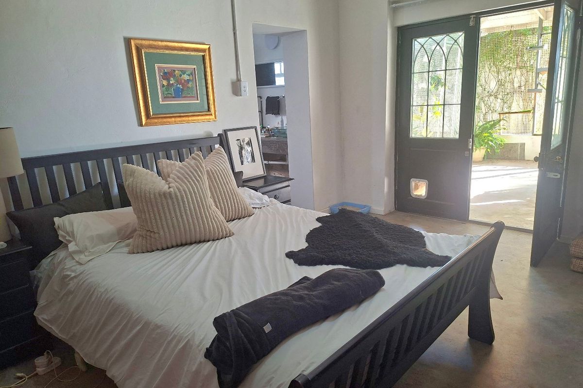 Bedroom featuring direct access to an outdoor patio through glass-paned french doors with an integrated pet door.