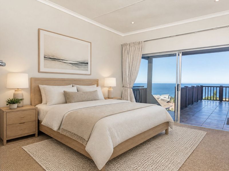 A well-maintained bedroom featuring neutral tones, carpet flooring, and large sliding glass doors that open onto a balcony with ocean views.