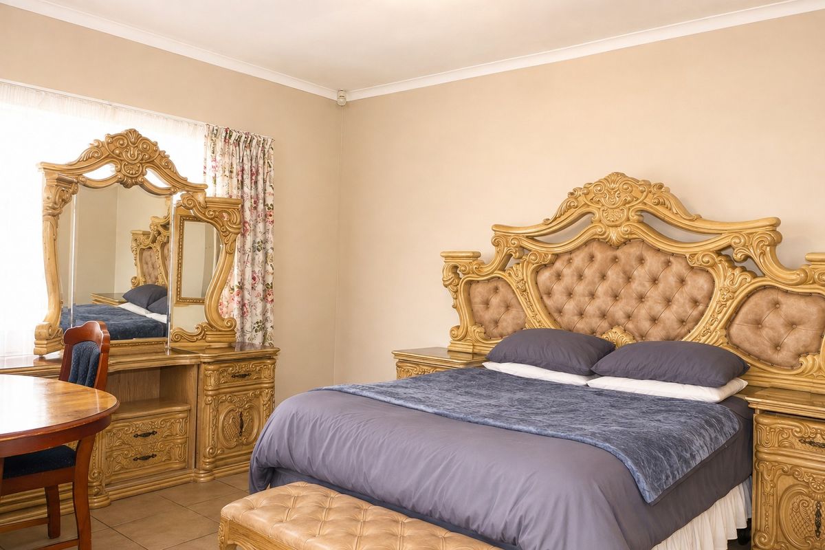 A spacious bedroom featuring neutral wall tones, tiled flooring, and coved ceiling detailing, providing a functional and well-maintained living space.