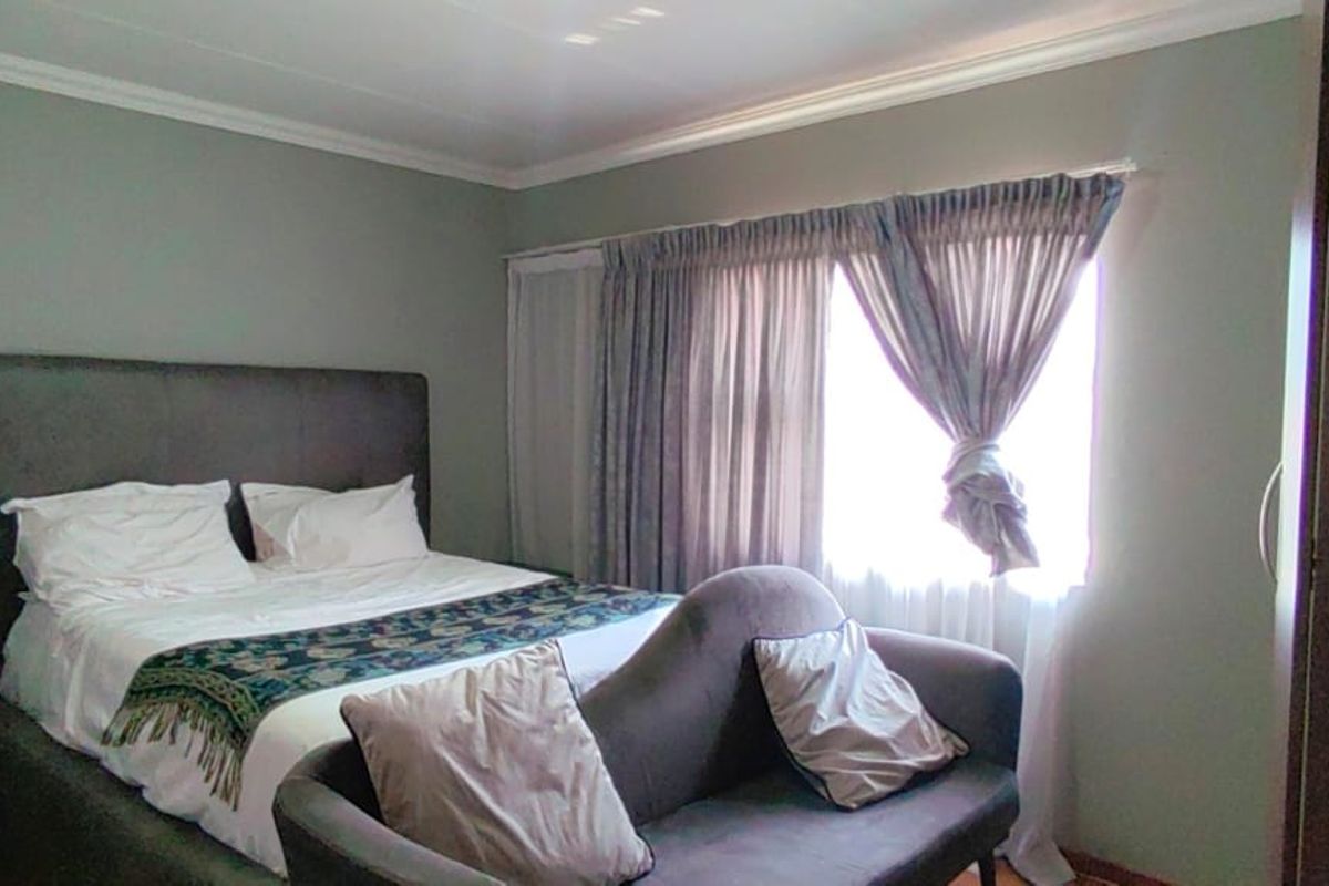 A bedroom featuring neutral wall tones, coving, and a built-in wardrobe, providing a functional and comfortable sleeping space.
