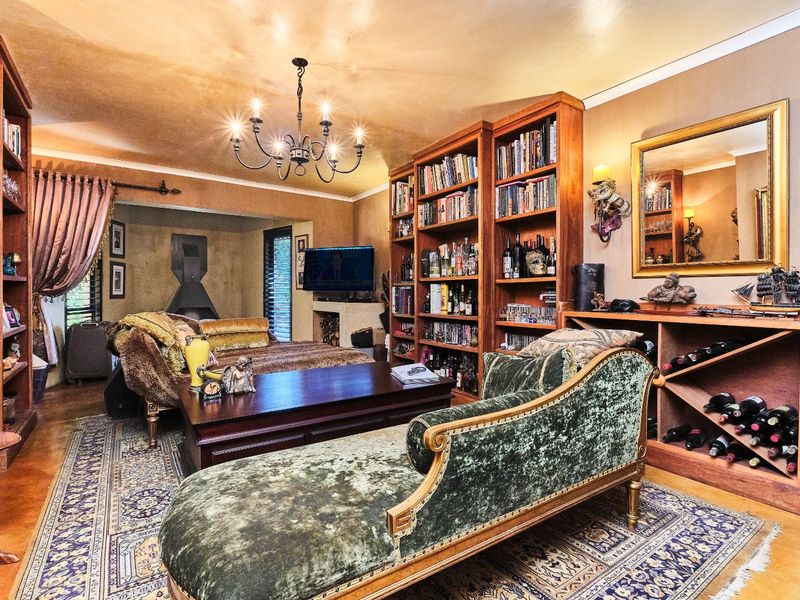 A cozy living room featuring extensive built-in wooden shelving, a dedicated wine storage unit, and a fireplace, creating a warm and inviting atmosphere.