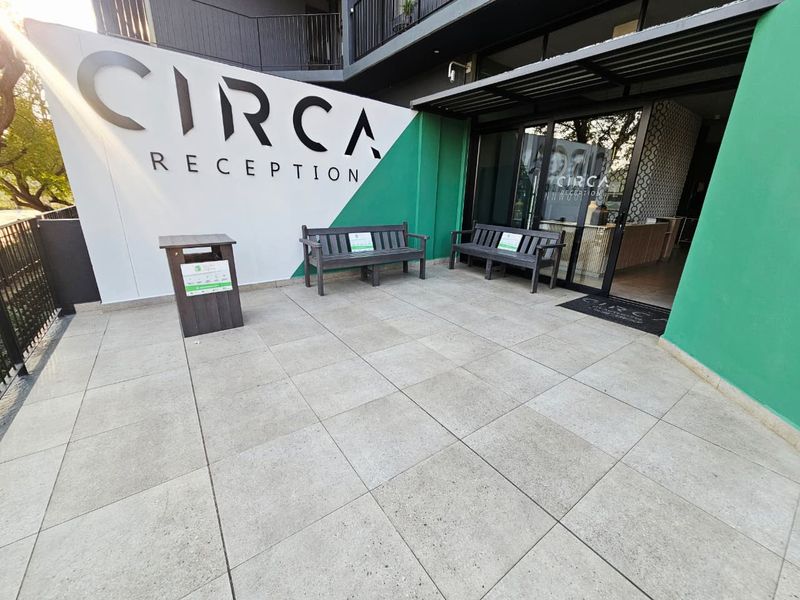 The entrance area of the Circa apartment complex, featuring modern tiled flooring, clear signage, and glass access doors.