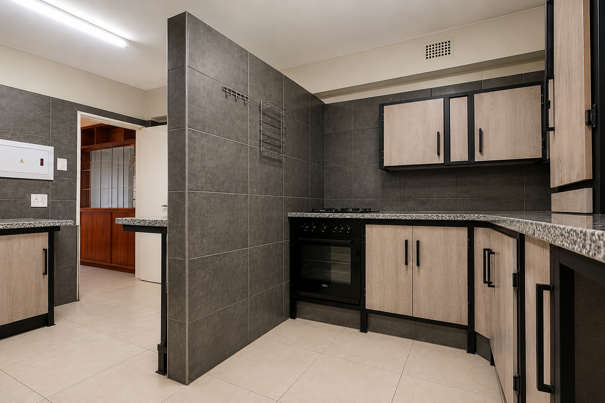 Modern kitchen featuring dark tiled walls, light wood-finish cabinetry, granite countertops, and a built-in oven with gas hob.
