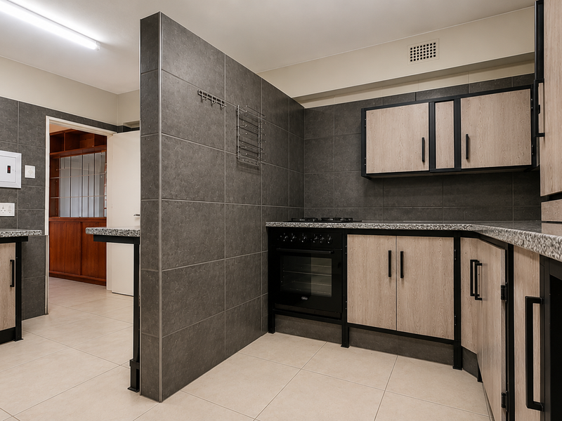 Modern kitchen featuring dark tiled walls, light wood-finish cabinetry, granite countertops, and a built-in oven with gas hob.