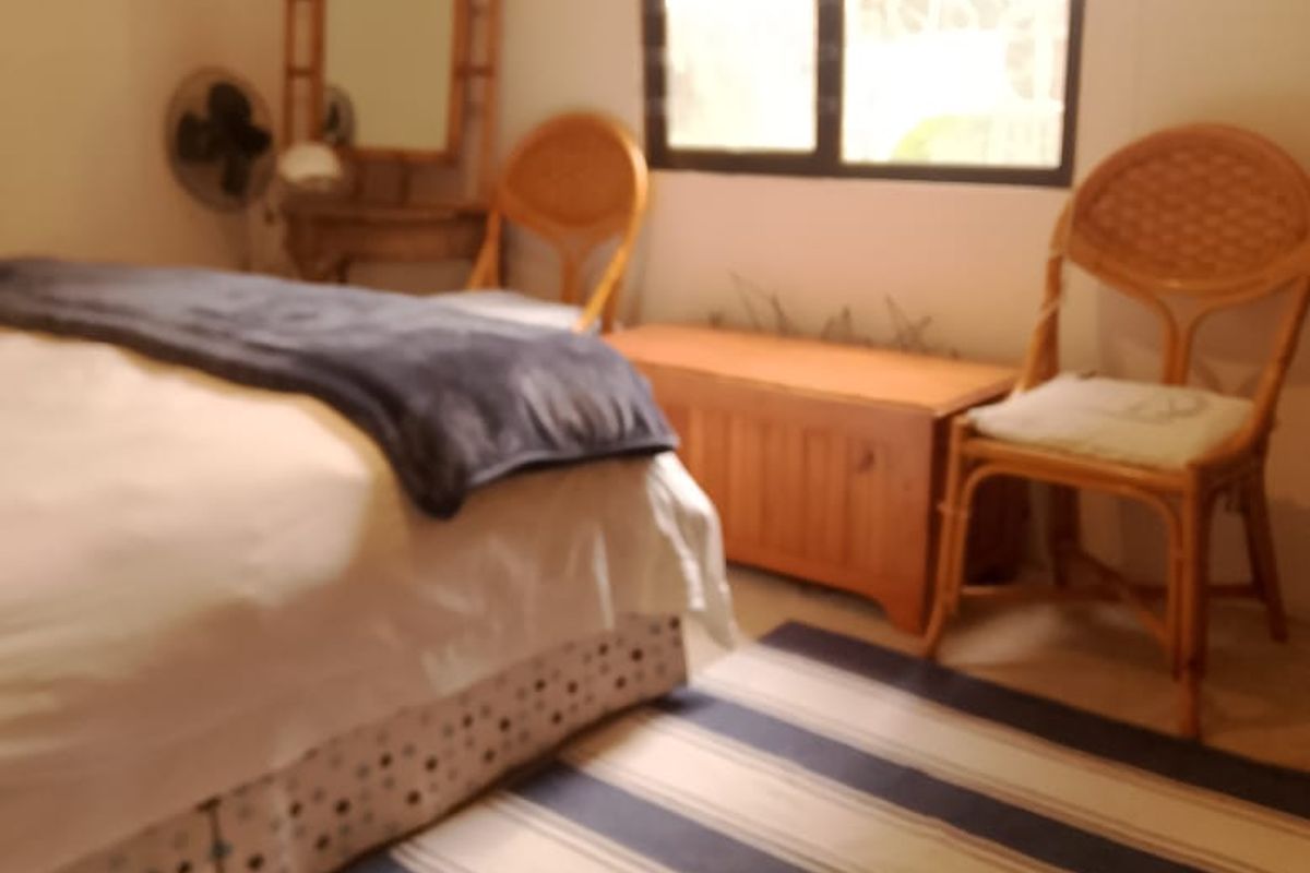 A bedroom featuring a window with a curtain rail, providing natural light to the space.