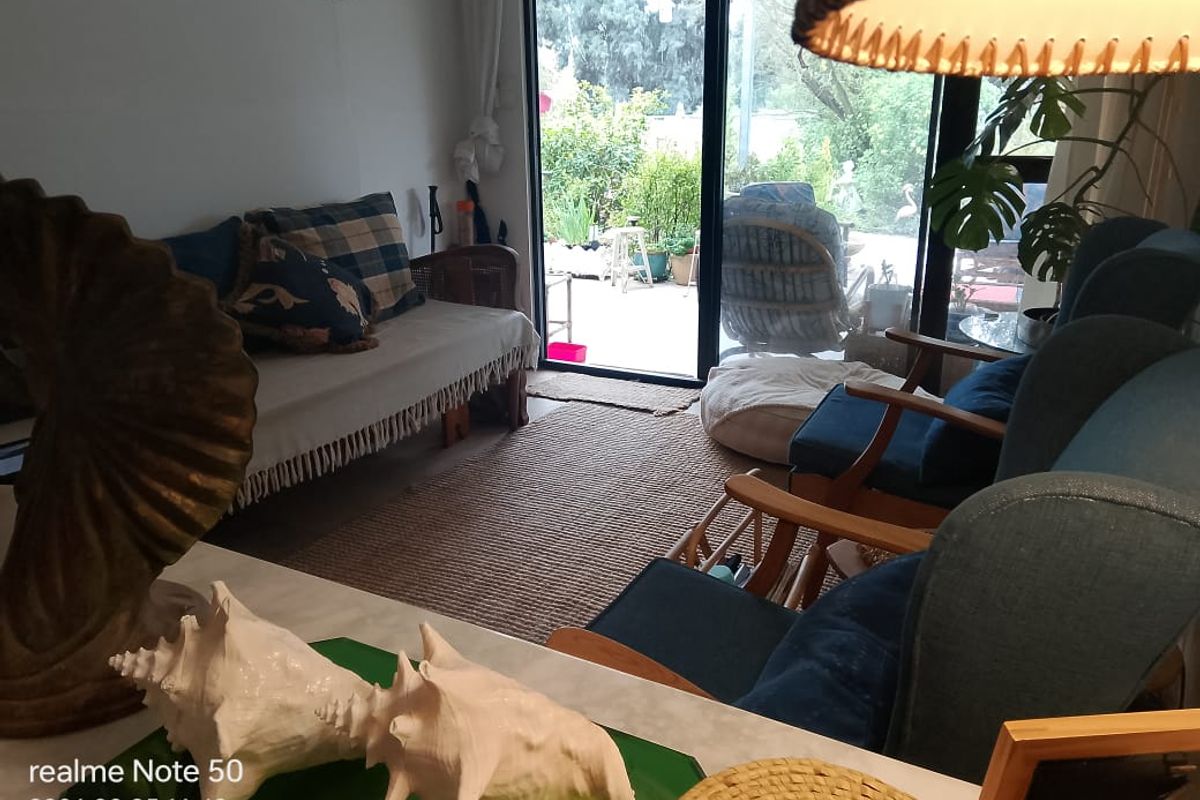 A cozy living room featuring large sliding glass doors that provide direct access to an outdoor patio area.
