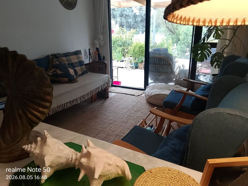 A cozy living room featuring large sliding glass doors that provide direct access to an outdoor patio area.