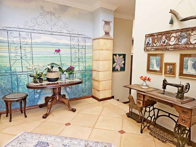 An inviting entrance hall featuring decorative tiled flooring and a large-scale landscape mural, creating a unique and characterful welcome to the home.