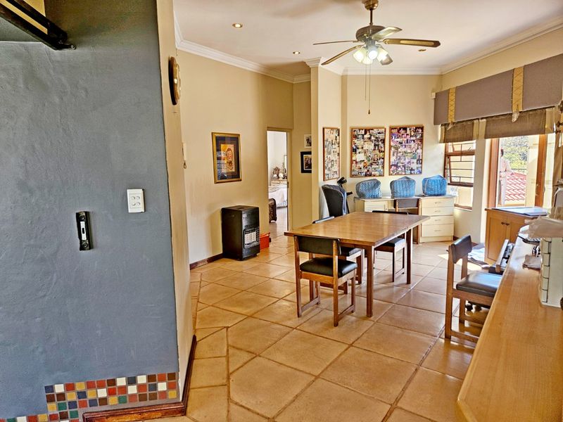 Open plan living and dining area featuring tiled flooring, recessed lighting, and a ceiling fan, providing a functional and versatile space.