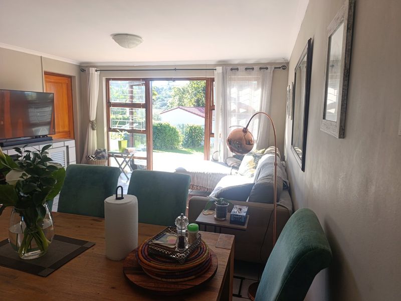 Open plan living and dining area featuring sliding glass doors that provide natural light and access to the outdoor patio space.