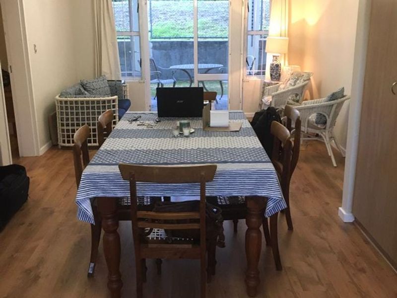 Dining room featuring laminate flooring and a sliding glass door providing access to an outdoor patio area.