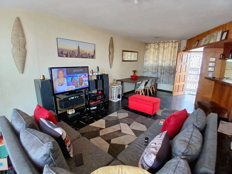 Open plan living and dining area featuring a breakfast bar and direct access to the entrance.
