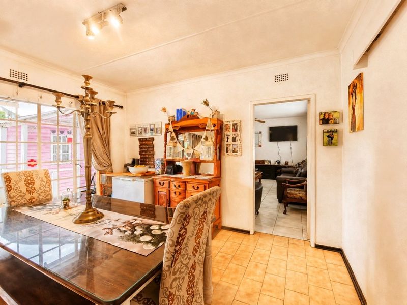 Dining room featuring ceramic tile flooring, a sliding glass door providing natural light, and a ceiling-mounted spotlight fixture.