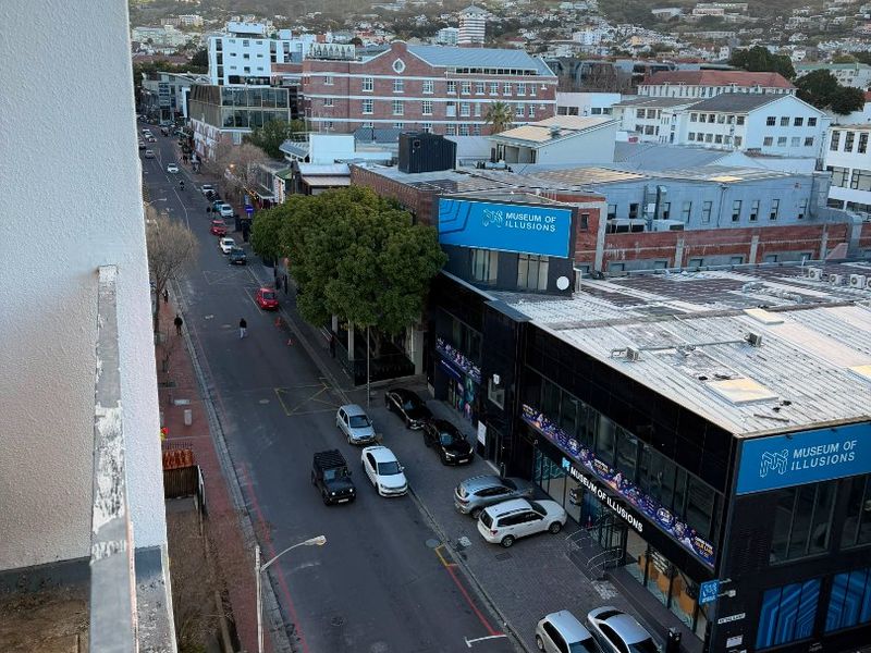 Elevated urban view overlooking the street and surrounding cityscape with Lion's Head mountain in the background.
