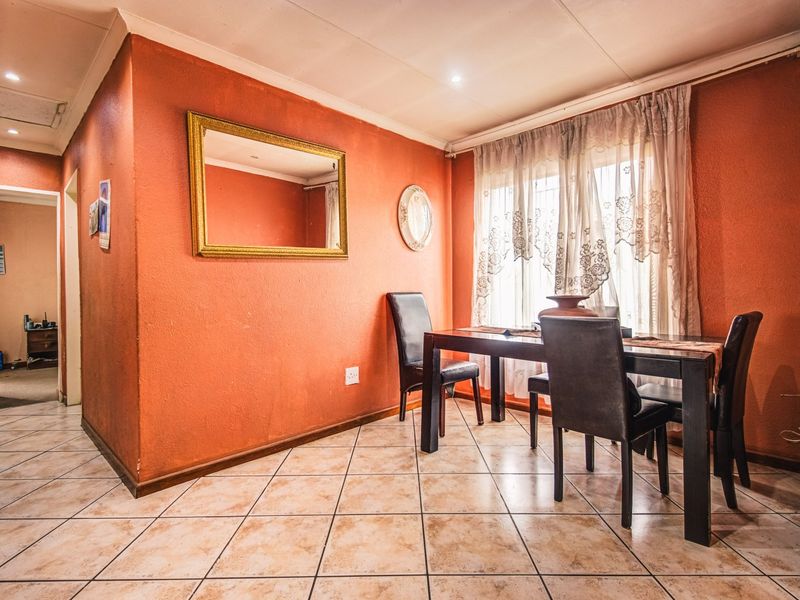 Dining area featuring tiled flooring and recessed lighting, offering a functional space for meals with potential for cosmetic updates to modernize the interior.