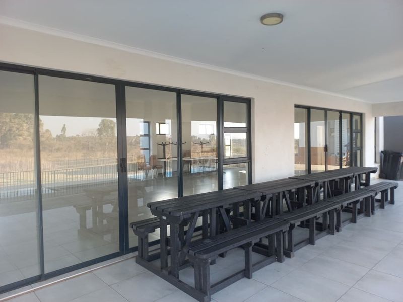 A spacious covered patio featuring large sliding glass doors that provide seamless access to the interior living areas.