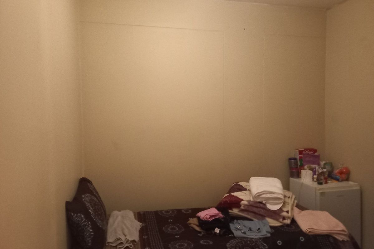A small bedroom space with plain walls and basic finishes, suitable for renovation or restyling to enhance its appeal.