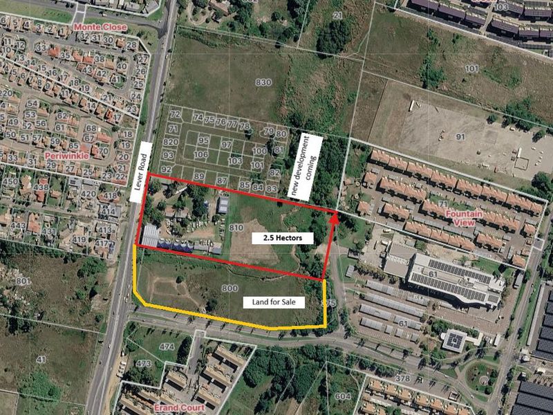 Aerial view of a commercial land parcel for sale, highlighting boundaries and surrounding infrastructure in a developed urban area.