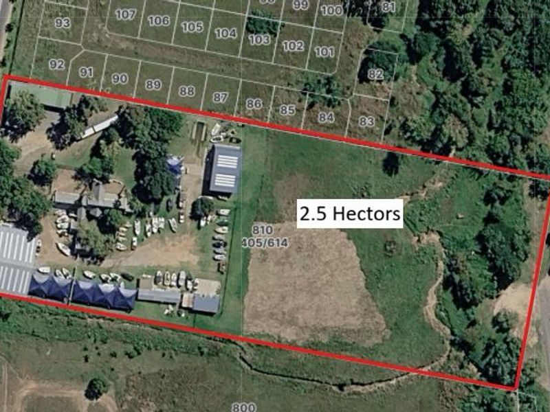 Aerial view of a 2.5-hectare commercial property featuring multiple structures, paved areas, and significant undeveloped land, with direct access from Lever Road.