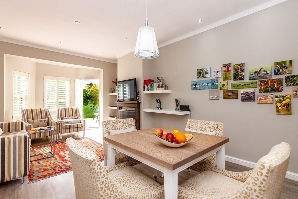 A bright and well-maintained living area featuring a fireplace, recessed lighting, and direct access to the garden through glass doors.