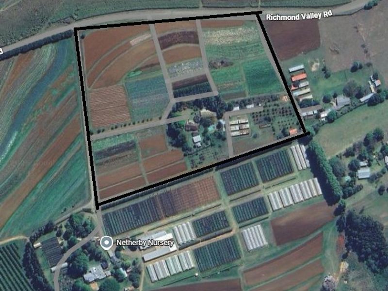 Aerial view of the farm property showing cultivated fields, nursery infrastructure, and access roads with marked boundaries.