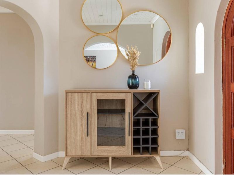Welcoming entrance hall featuring classic arched doorways, neutral wall tones, and durable tiled flooring, providing a warm and inviting transition into the home.