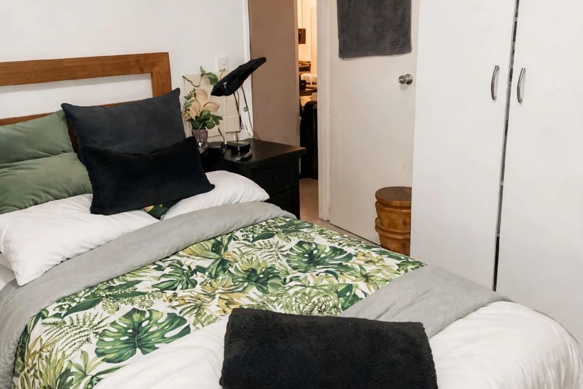A bedroom featuring a built-in wardrobe and access to an adjoining hallway.