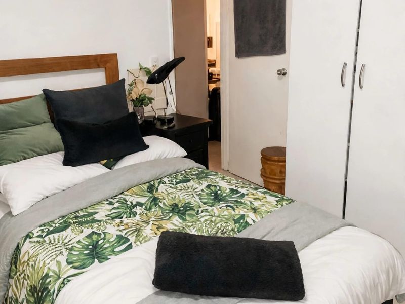 A bedroom featuring a built-in wardrobe and access to an adjoining hallway.