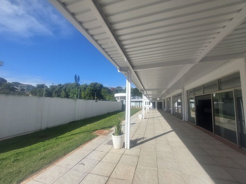 Spacious covered patio area with tiled flooring, metal roofing, and large sliding glass doors providing access to the interior.