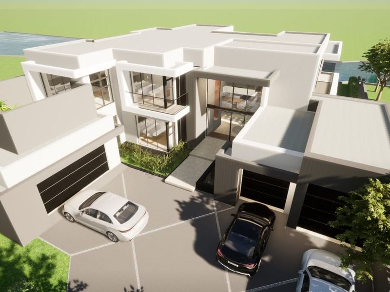 An aerial perspective of a modern luxury residential property featuring a multi-car garage, clean architectural lines, and expansive glass elements.