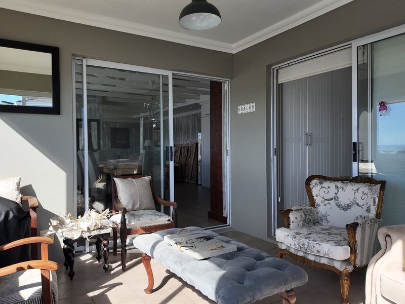 A covered patio area featuring tiled flooring and large sliding glass doors that provide access to the interior living space.