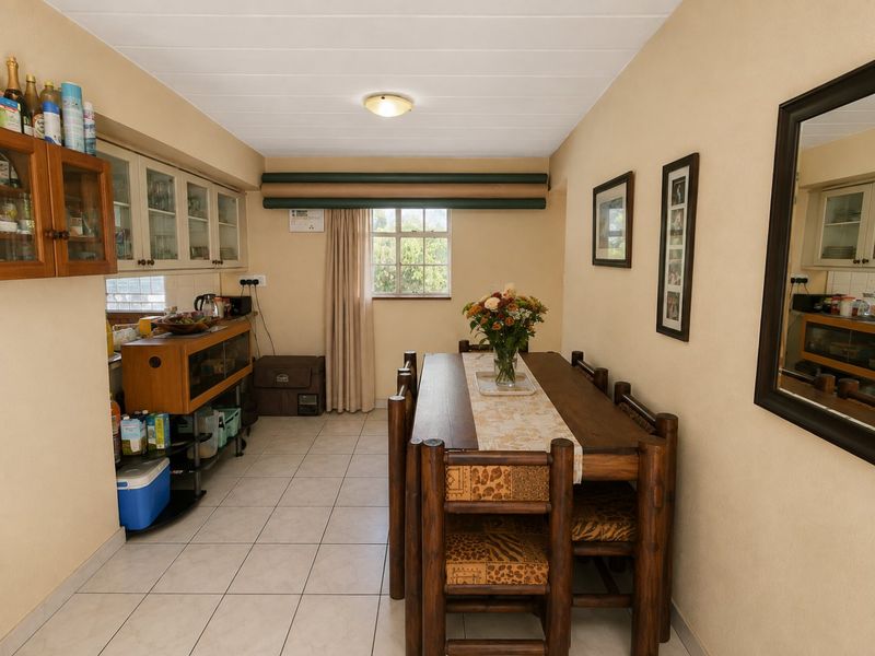 A functional dining area featuring tiled flooring, neutral wall finishes, and built-in cabinetry, providing a practical space for meals.