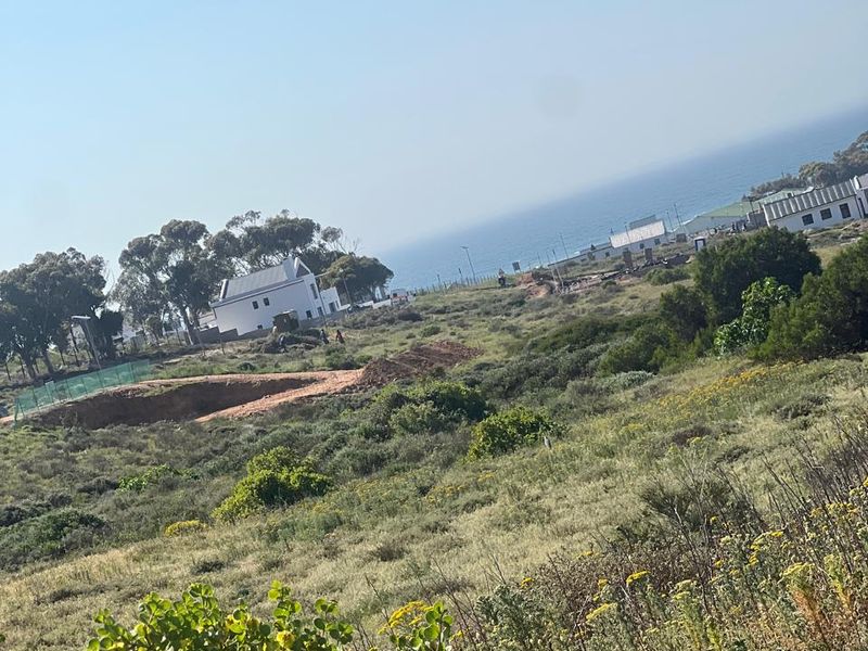A scenic view of the coastal landscape and surrounding residential area, showcasing the natural terrain and proximity to the ocean.