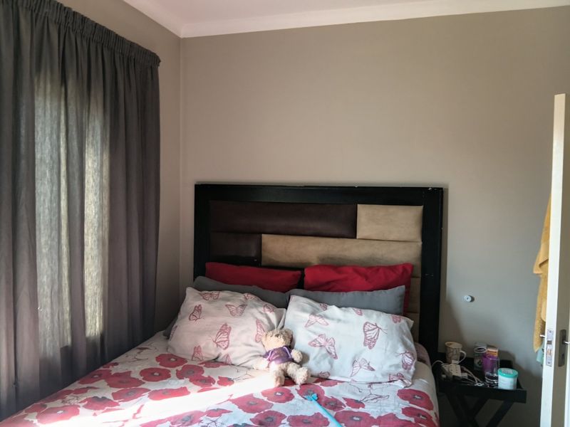 A standard bedroom featuring neutral wall paint and coving, providing a functional space for rest.