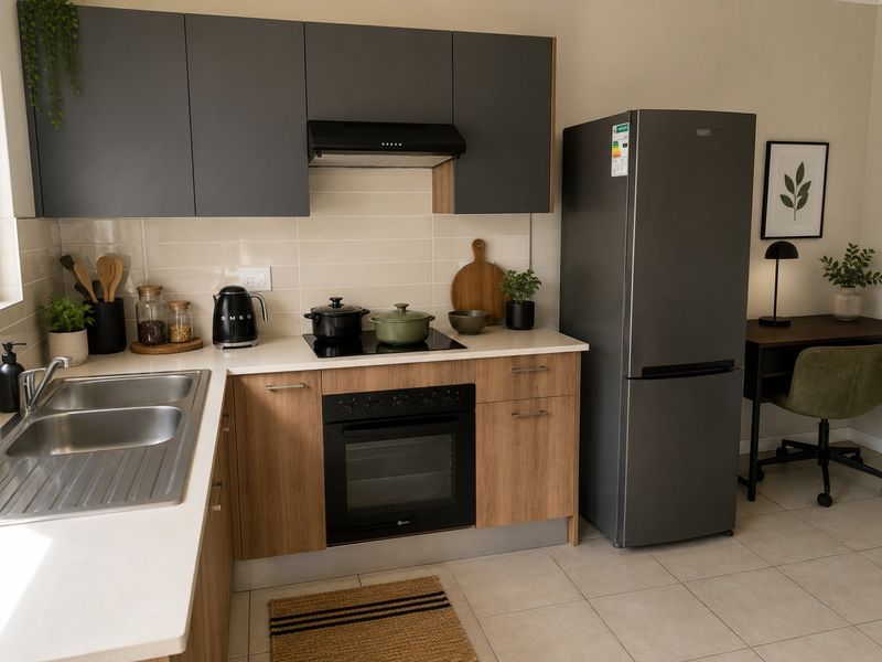 Modern kitchen featuring dark grey upper cabinets, wood-finish lower cabinetry, stone countertops, integrated oven, hob, and extractor fan with a tiled backsplash.