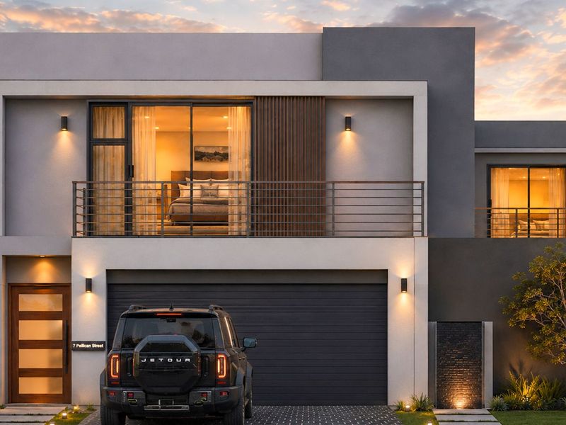 Modern double-story residential facade featuring a balcony, integrated garage, timber entrance door, and contemporary exterior lighting at dusk.