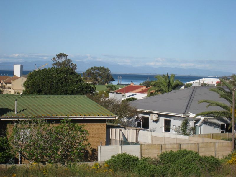 A scenic elevated view overlooking the surrounding residential neighborhood with distant coastal and mountain vistas.