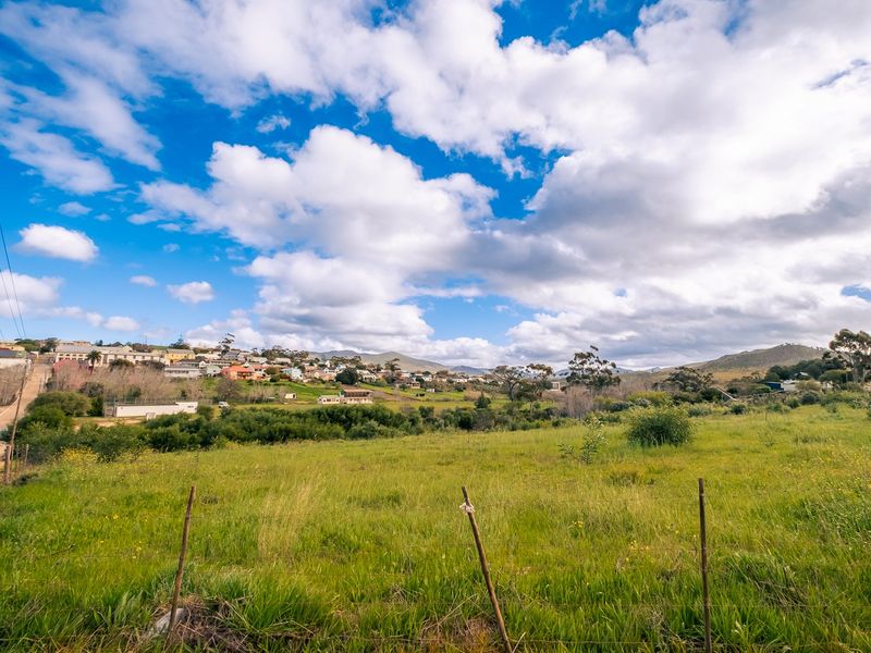 A scenic view of the surrounding landscape and residential neighborhood from the vacant residential land.