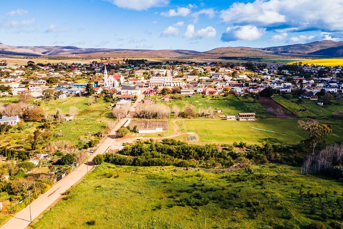An aerial view of the residential land parcel showing its location within the surrounding town and landscape.
