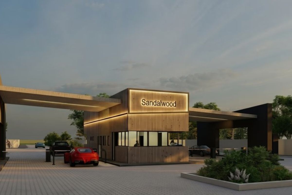 A modern architectural rendering of the Sandalwood estate entrance, featuring a contemporary security gatehouse with timber cladding and integrated lighting.