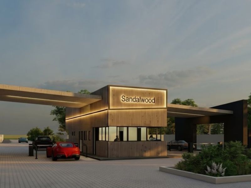A modern architectural rendering of the Sandalwood estate entrance, featuring a contemporary security gatehouse with timber cladding and integrated lighting.