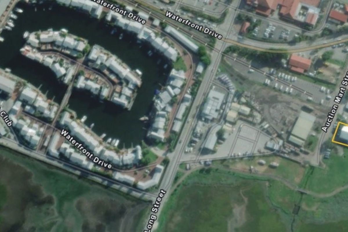 Aerial view of the commercial property location, highlighting its proximity to the waterfront, marina, and local road infrastructure.
