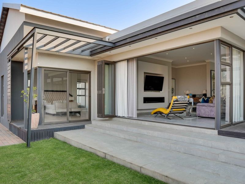 Modern covered patio featuring seamless indoor-outdoor flow with bi-fold doors, recessed lighting, and direct access to the garden.