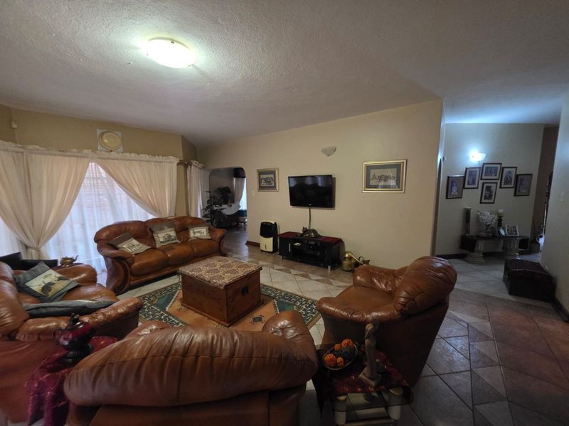 Spacious living room featuring tiled flooring and neutral wall tones, providing a comfortable and functional area for relaxation.