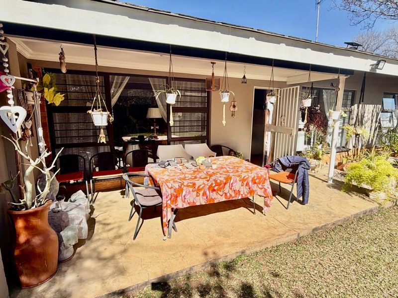 A covered outdoor patio area featuring a concrete floor, providing direct access to the home through sliding glass doors.