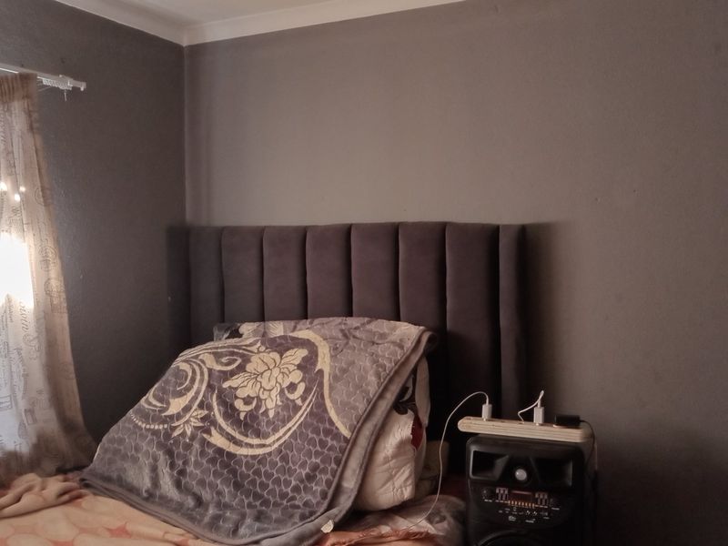 A bedroom featuring dark grey painted walls and decorative coving.