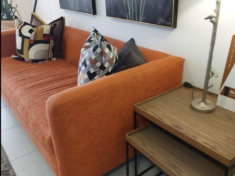 A well-maintained living area featuring neutral tiled flooring and clean wall finishes, providing a comfortable and functional space.