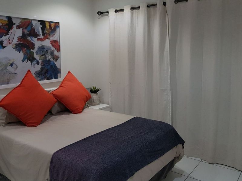 A bedroom featuring tiled flooring and a curtain rod, providing a neutral base for personal styling.